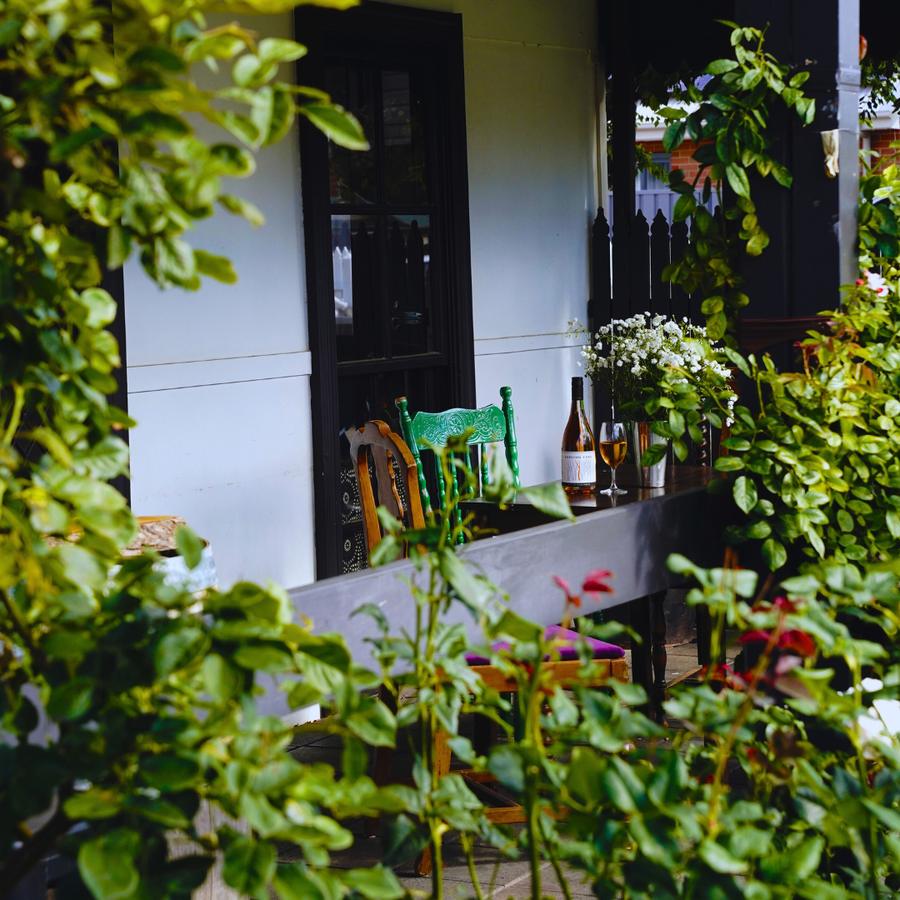 The entrance to Aranya Acres at 810 Norton Road, Wamboin, framed by greenery and wine bottles