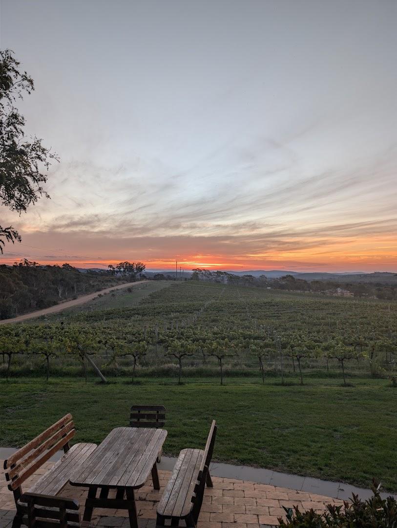 The lawn and vineyard event space at Aranya Acres, Wamboin, at dusk