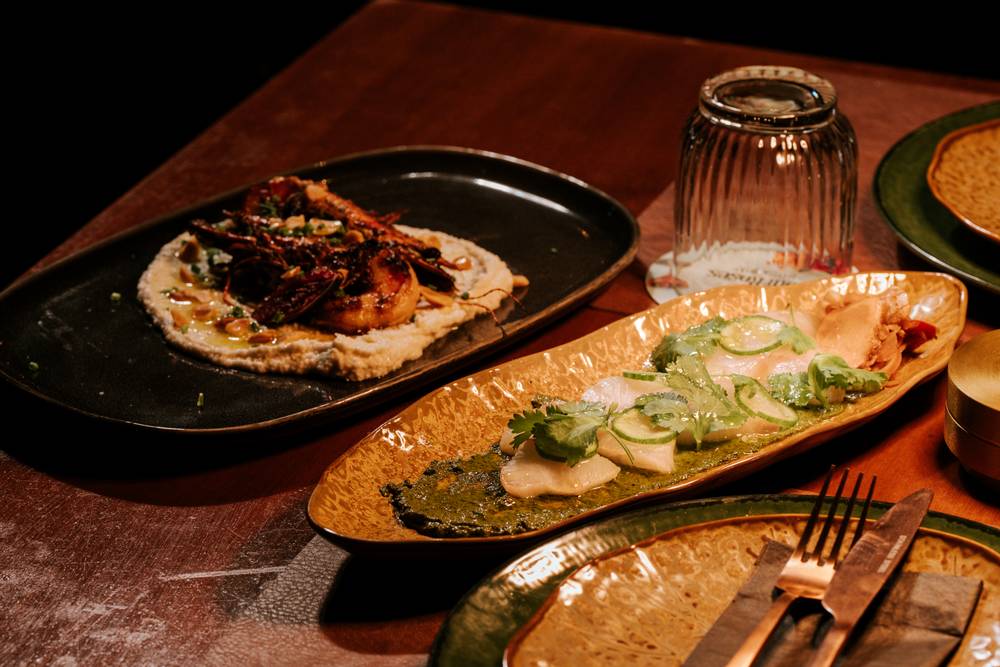 Chargrilled king prawns and market fish sashimi — native Australian dining at Aranya Acres