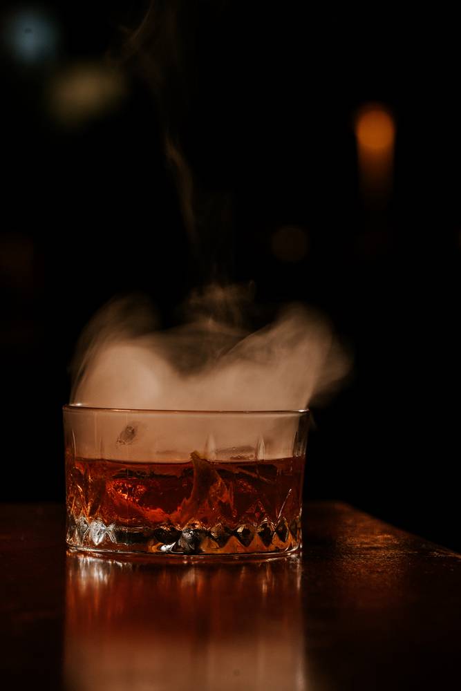 A smoking Bloody Shiraz craft cocktail at the Aranya Acres cocktail bar
