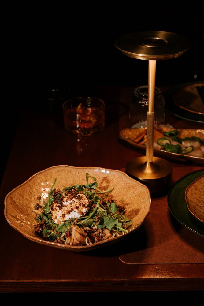 Heirloom roast salad beside the brass table lamp at Aranya Acres
