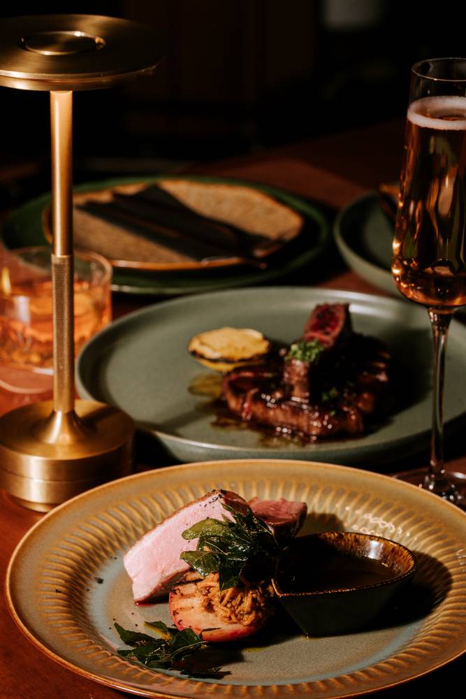 Crispy duck and wagyu rump by candlelight at Aranya Acres restaurant near Canberra